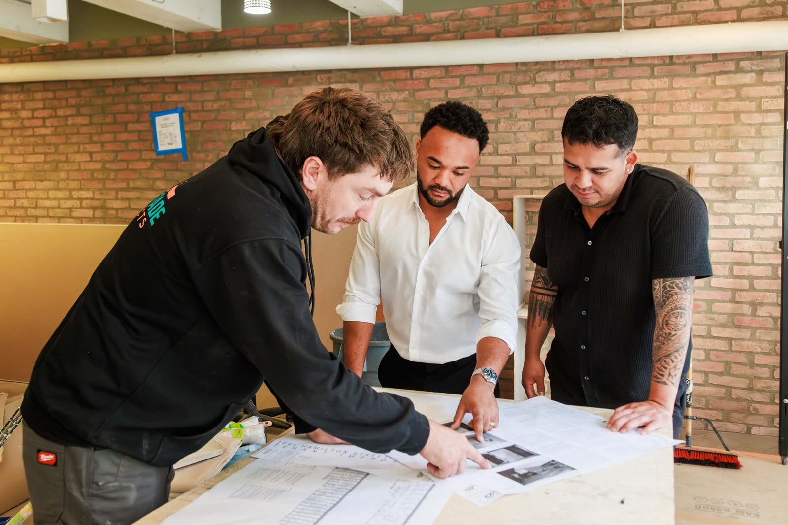 Shonah and the Westrade team going over the drawings on site